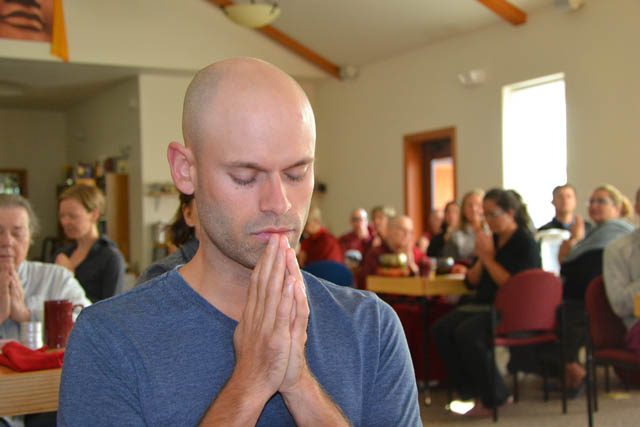 Spokane resident Stephen Taul joins abbey residents and guests in the food offering prayer before lunch