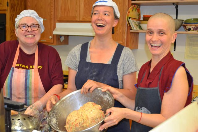 Ven. Thubten Jampa teaches guests Patty Jo Shockley and Fabienne Pradelle to make German bread