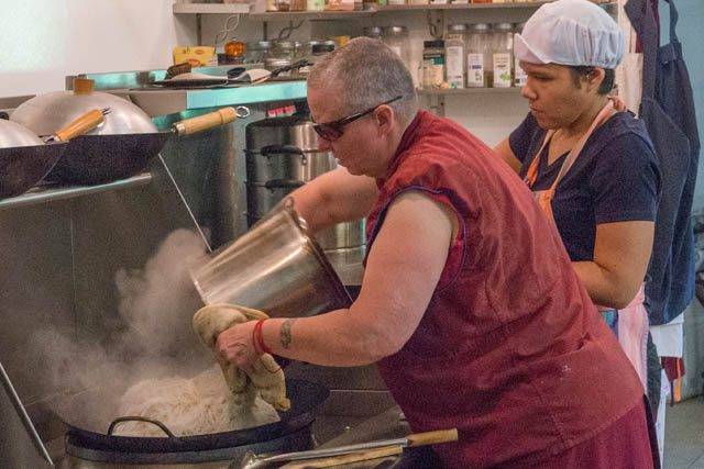 Ven. Thubten Tsultrim and trainee Christina Manriquez serve as the day's cooking team. At the abbey, everyone takes turns cooking for the community