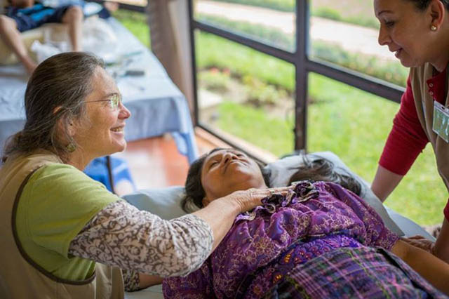 Cynthia Price, lead author of the body awareness research, working with a woman and a translator in Guatemala
