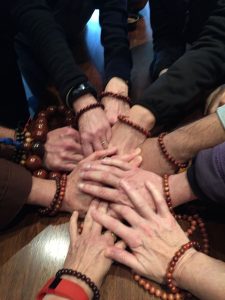 People wearing malas celebrate a "Listening to the Sound of Silence” retreat at the Trappist Abbey in Carlton, Oregon. The retreat was taught by Jerry Braza from the Order of InterBeing.