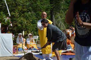 Lani Kawasaki wields a shovel at the ground-breaking ceremony, with support from Rev. Utsumi Gyoshu from the Great Smoky Mountains Peace Pagoda, under construction in Tennessee