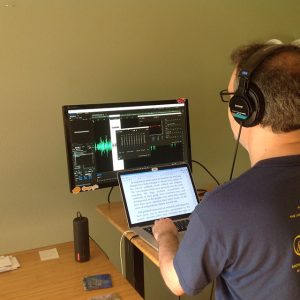 Publisher Steve Hanlon evaluates a volunteer’s voice recording, to see if adjustments are needed