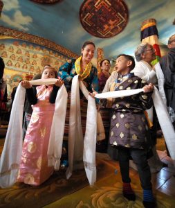 Chemi Chekal and her children preparing to offer respects before the altar at Sakya Monastery for Losar