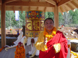 Dzogchen Khenpo Choga Rinpoche with the prayer wheel in the Sawtooth Botanical Gardens in Sun Valley, Idaho