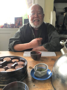 Nomura enjoying tea and cookies at One Pine Hall in Seattle