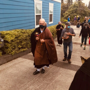 Nomon Tim Burnett in full robes leads Red Cedar Sangha members in a last walk around their former zendo