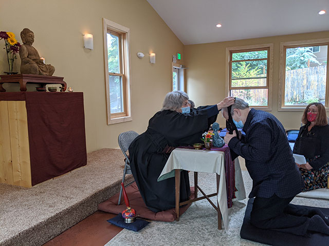 In the only use of the new zendo since its completion, Grady Hongaku Tarbuton receives his rakusu, which signifies taking the precepts, from Guiding Teacher Abby Mushin Terris