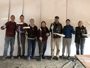 Sangha members exult after priming the new zendo’s exterior, in 2018.  Left to right:  Rich Taigen Duncombe, Trevor Ruiz, Libby Zuiko Bailey, Abby Mushin Terris, Michael Stanley, Mary Leigh Doryu Burke, Judy Junyo Good.