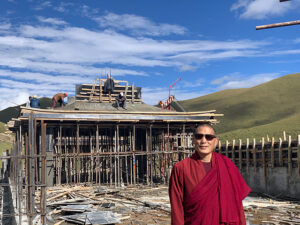 Dza Kilung Rinpoche on the roof of the new shedra, replacing the structure destroyed during the 2016 fire