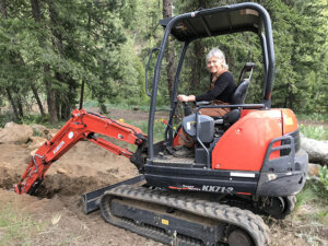 Sarah Conover digging trench for electric conduit on Cascade Hermitage property