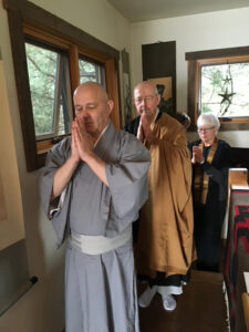 Kanzan John Slattery, Zenku Smyers Sensei, and Tetsudo Pat May walking into the Mountain and Waters Zendo for Kanzan's priest ordination ceremony