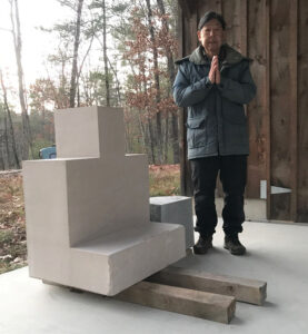 Sculptor Thomas Matsuda with the stone for the Buddha sculpture at his studio in Leverett, Massachusetts