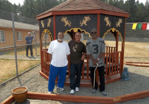 George O. Mitchell (left), Malone (center), and Rickey Calhoun guided  the project to build a meditation pagoda at McNeil Island civil commitment center