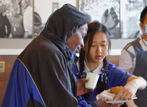 In 2019, Tzu Ching volunteers serving hot food at Union Gospel Mission in the Seattle University District