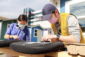 Tzu Ching student volunteers assemble chairs for Rosie's Tiny Home Village near the University of Washington