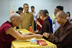 Ven. Chodron offers specially blessed Tibetan medicine pills to visiting sangha in Singapore