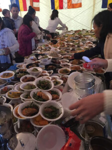 Lay people bring their best dishes to offer monks for the Cambodian New Year. Afterward, everyone shares