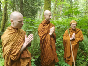 Luang Por  Passano, Ajahn Kovilo, and Ajahn Nisabho, pray during a 2023 monastery land search excursion near Issaquah’s Cougar Mountain.