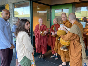 The founding bhikkhunis of Karuna Buddhist Vihara, Ayyā Santussikā and Ayyā Cittānandā, join Ajahn Kovilo and Ajahn Nisabho for morning alms round at Pike Place Market.