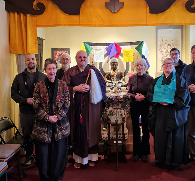 Portland Buddhist Priory sangha members in the meditation hall. Rev. Master Leon Kackman in at  center left