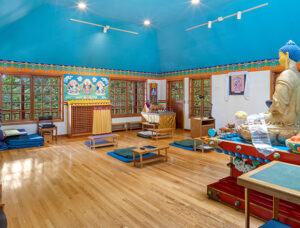 The main meditation room with hand painted Buddhist artwork and murals