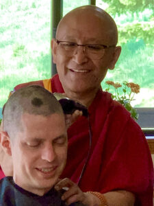 Geshe Dadul Namgyal does the ceremonial head-shaving before ordaining a new monk, Venerable Thubten Konchog