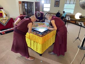 Geshe Lobsang Yeshi destroys the sand mandala, reflecting the impermanence of the cosmos
