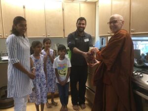 Sangha  members offering food to Ayya Ahimsa, reflecting people’s learning about dana