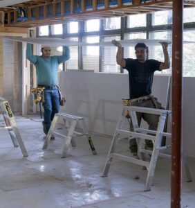 Workers installing drywall as they build out the new practice space