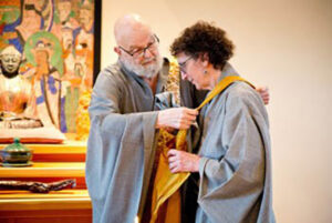 Zen Master Ji Bong in 2015 gave dharma transmission to Feng, in a traditional ceremony at Blue Heron Zen Community