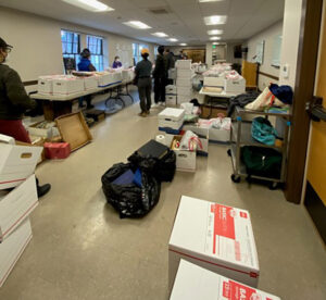 Boxes of files that were saved from the  fire, are being digitized by temple volunteers at a temporary location