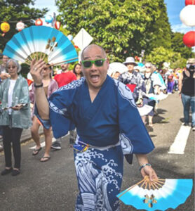 Seattle Betsuin Chairperson Tyler Moriguchi, dancing a leading role in a past Bon Odori festival