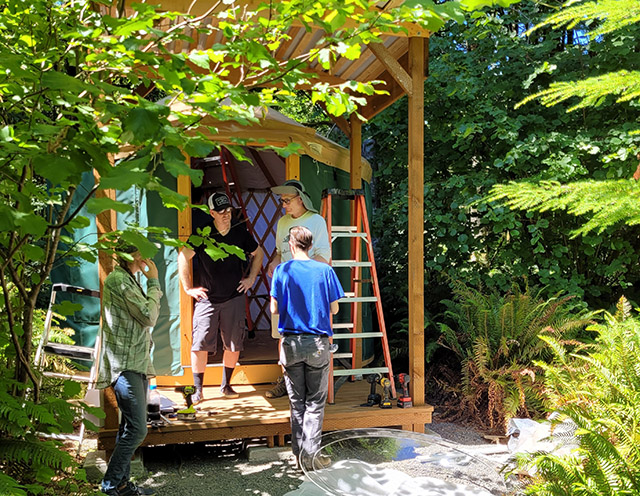 A team builds one of the new yurts, which have created 10 new single rooms for Cloud Mountain