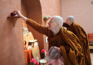 At Dhammadharini Monastery in California, Ayya Suvijjana Bhikkhuni and Ayya Niyyanika Bhikkhuni decorate with rose petals, to celebrate the early establishment of the monastery