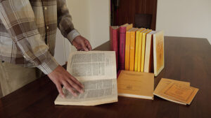 Pariyatti Executive Director Brihas Sarathy, flicks through one of the original books by the Burma/Myanmar Tipitaka Association