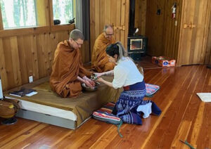 Salisa Suddhisanont pours scented water over Taan Will’s hands, as part of the hand-washing ceremony