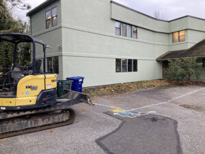 Expanding our zendo takes the first step: a line on the pavement showing the new footprint