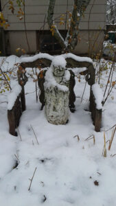 A Jizo statue, guardian deity of children and travelers, covered with snow in front of the sangha house