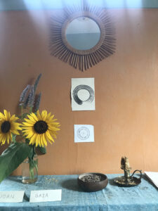 The simple Sangha House altar, including the names of war zone nations where people are suffering