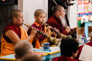 Jetsünma and Dorlop Chönyi Sangmo playing traditional instruments during a ceremony at the Namchak Retreat Ranch. Lama Lungrig Nyima at the rear.