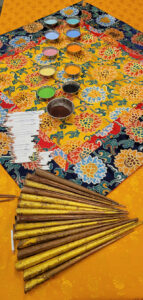 The nuns used a variety of colored sands (dyed using natural elements), white colored pencils, and fluted funnels called chak-pur, to build the mandala