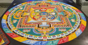 The finished sand mandala paid homage to Akshobhya Buddha, the blue figure seen in the middle of the design