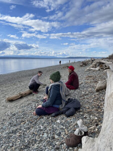 A sangha member meditates on the Richmond Beach.
