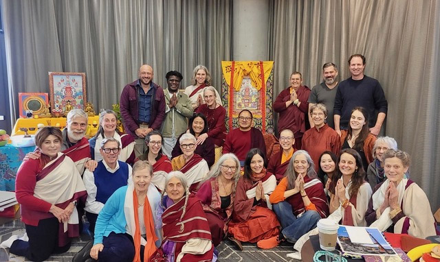 Group photo of January, 2025, Chetsun Nyingthig retreat January 2025, with Adzom Gyalse Rinpoche on the throne, Lama Jacqueline Mandell far left