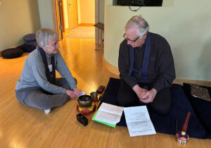 Claire Johnston and Don Olson train in the use of the bells for their service positions