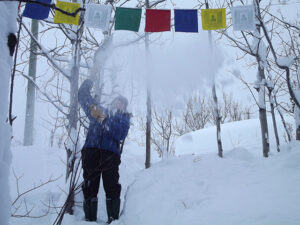 Cheryl Buchan shoveling snow at Roger Horner’s retreat cabin