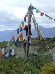Raising prayer flags on Montana Mountain