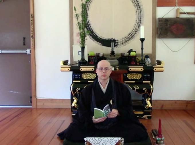 Tendo Zenji, book in hand, before the Zen altar.Photos by: Tendo, Andrew Woods