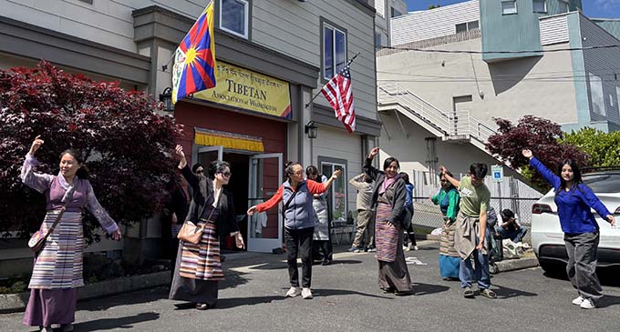 Members of the Tibetan community dancing gorshey, a Tibetan circle dance during the open house outside the Tibetan Community Center